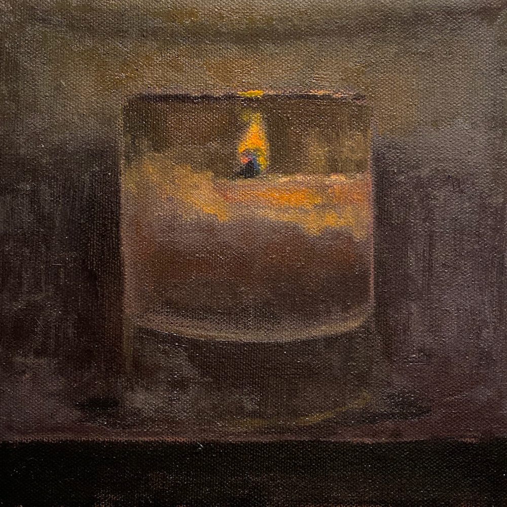 Single lit candle in the night